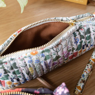 Inside view of the quilted pouch showing fabric lining and gold zipper detail
