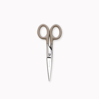 Pair of scissors with brown handles on a white background