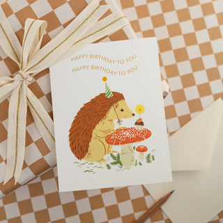 Close-up detail of Birthday Hedgehog birthday card showcasing the gold foil stamping accents and delicate watercolor textures of the charming hedgehog illustration from Oana Befort's original hand-painted artwork