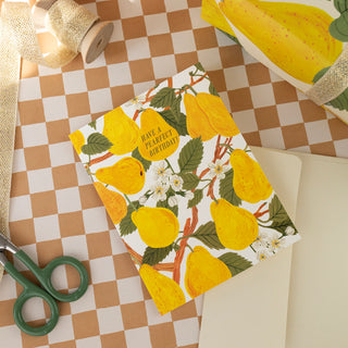 Pearfect Birthday greeting card styled with coordinating botanical gift wrap in the background, showcasing Oana Befort's delicate pear illustration and the cohesive design aesthetic of Botanica Paper Co.'s stationery collection