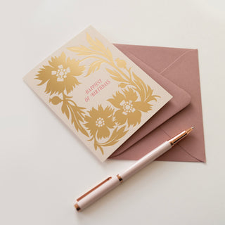 Close-up detail of Gold Poppies Birthday greeting card by Oana Befort for Botanica Paper Co. showcasing luxurious gold foil stamping on poppy petals and stems against warm white matte cardstock