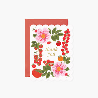 Illustrated greeting card with a scalloped white border and a coral-red envelope behind it. The card is decorated with pink flowers, red berries, green leaves, and small gold text reading 'thank you'.