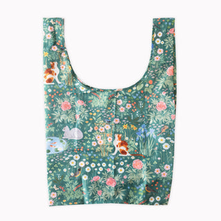 A reusable tote bag with a green background and a detailed botanical and animal print featuring cats, rabbits, flowers, and birds, shown flat against a white background.