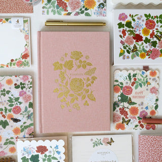 Reverie planner styled with coordinating stationery from the same collection by Oana Befort for Botanica Paper Co., highlighting the gold foil details, satin ribbon bookmarks, and cohesive lush floral aesthetic