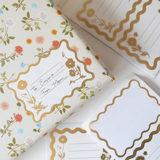 Flora Decorative Labels, Pack Of 6 illustrated by Oana Befort for Botanica Paper Co. being used on a present.