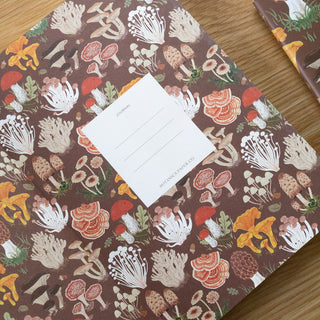 Journal with mushroom pattern on a wooden surface