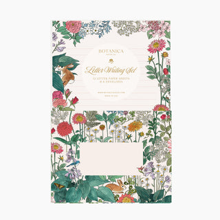 A botanical-themed letter writing set by Botanica Paris, featuring a decorative cover with colorful wildflowers, leaves, bunnies, and birds, plus two blank lined paper sheets and two envelopes shown on a light gray background.