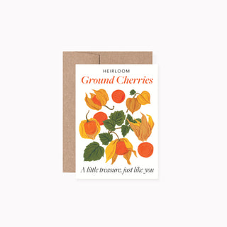 A greeting card with a kraft envelope, featuring an illustration of ground cherries with the text 'HEIRLOOM Ground Cherries' and 'A little treasure, just like you'.