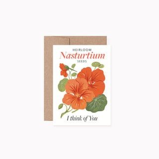 A greeting card with a kraft envelope, featuring an illustration of orange nasturtium flowers and green leaves on a white card, with the text 'HEIRLOOM Nasturtiium SEEDS' and 'I think of You'.