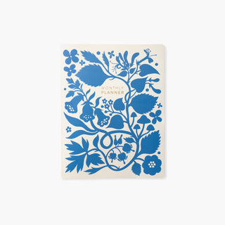 Blue Floral Undated Monthly Planner illustrated by Oana Befort for Botanica Paper Co. featuring a blue silhouette of florals with a gold foil title.