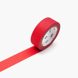 A roll of bright red washi tape with a strip unrolled diagonally, showing the white inner core with repeating black 'mt' branding, on a clean white background.