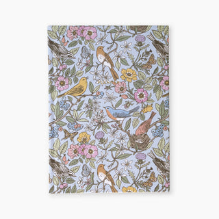 Songbirds Linen Bound Planner illustrated by Oana Befort for Botanica Paper Co. featuring botanical flowers and songbirds on a linen cover.