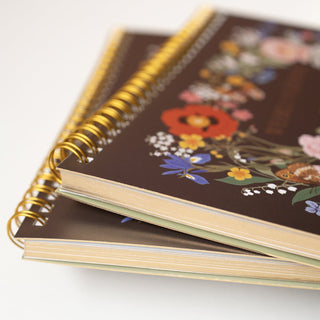 Close-up side view detail of the Wild Flowers Undated Weekly Planner illustrated by Oana Befort for Botanica Paper Co.