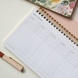 Close-up detail of an opened Reverie Undated Weekly Planner illustrated by Oana Befort for Botanica Paper Co.