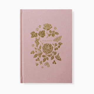 Reverie Linen-Bound Planner by Oana Befort for Botanica Paper Co. featuring soft pink book linen cloth cover with luxurious gold foil lush floral accents, 6.25" x 8.5" undated planner with elegant botanical design