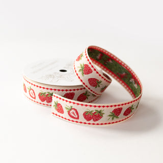 embroidered strawberry ribbon on a spool and white background