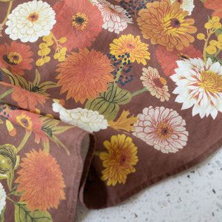 Close-up detail of the Fall tea towel by Oana Befort revealing the natural linen texture and intricate autumn leaf illustrations with rich seasonal colors printed using OEKO-TEX certified non-toxic inks