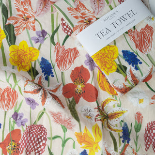 Close-up detail of the Spring tea towel by Oana Befort showing the fine European linen weave and delicate spring blossom illustrations with tender petals and new growth buds printed with OEKO-TEX certified non-toxic inks