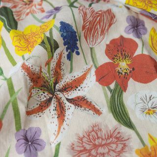 Fine detail of Spring tea towel showcasing Botanica Paper Co.'s botanical accuracy with tender spring foliage, blooming branches, and the premium European linen's organic texture that brings seasonal renewal to everyday moments