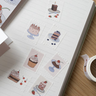 Die-cut washi tape with illustrations of desserts on a notebook page.