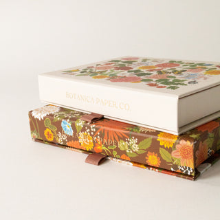 Two Russet Keepsake card boxes side by side with shimmering gold foil accents on the packaging by Botanica Paper Co.