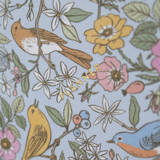 Close-up of the title of the Songbirds Linen Bound Planner illustrated by Oana Befort for Botanica Paper Co.