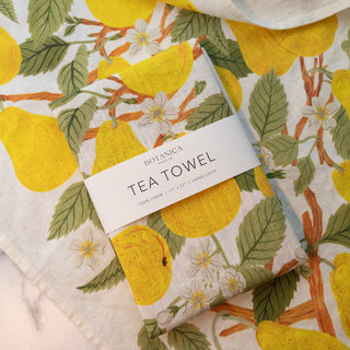 Close-up detail of the Pear Orchard tea towel by Oana Befort displaying the fine European linen weave and intricate pear tree illustrations with delicate fruit and foliage printed using OEKO-TEX certified non-toxic inks