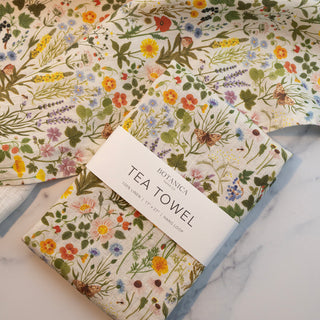 Detail of the linen tea towel’s loop for easy hanging, part of the BOTANIST illustrated home goods collection.