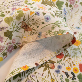 Close-up of the BOTANIST tea towel showing the soft linen texture and non-toxic botanical print in earthy tones.
